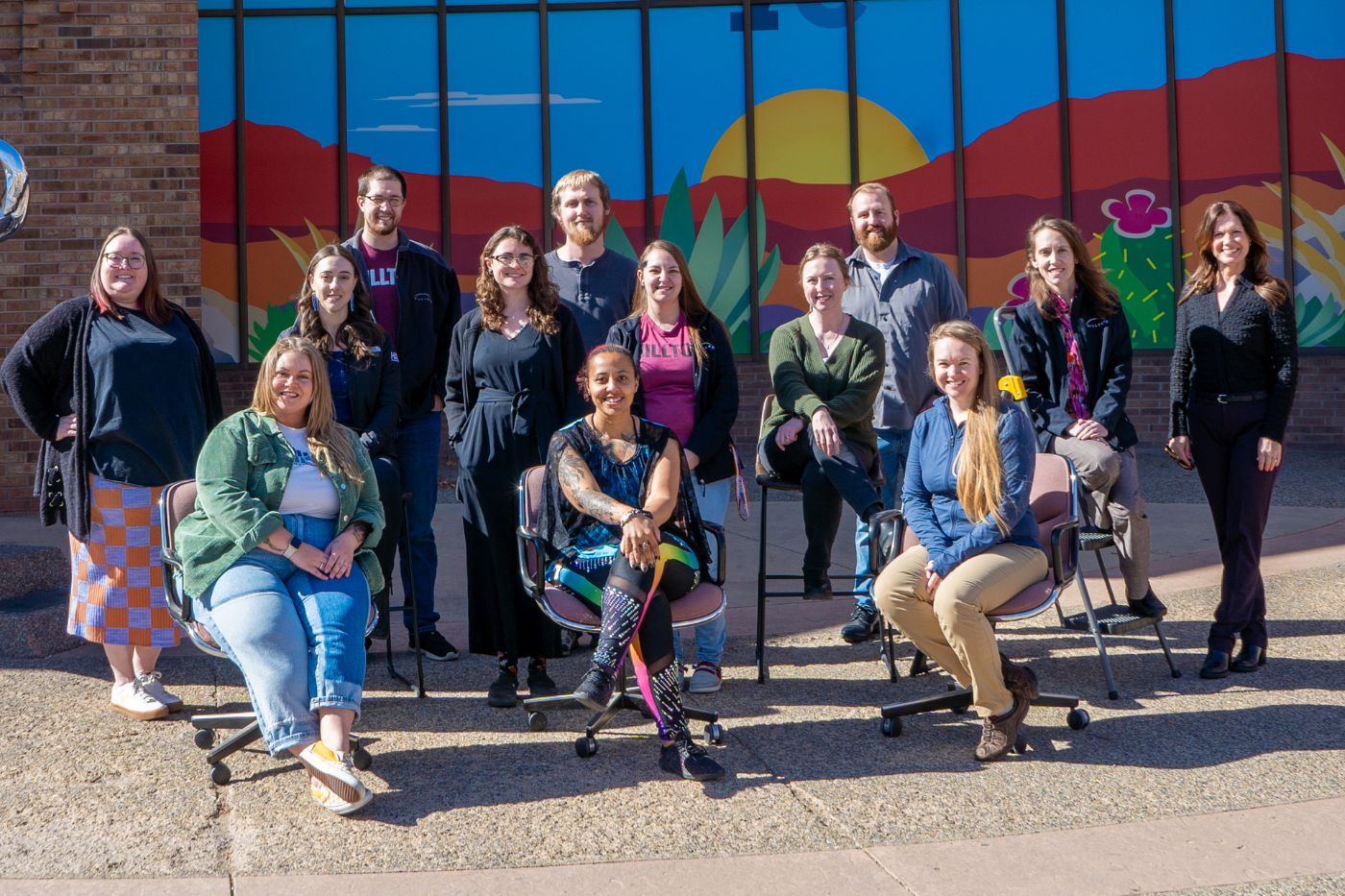 Group of young professionals smiling outside of building