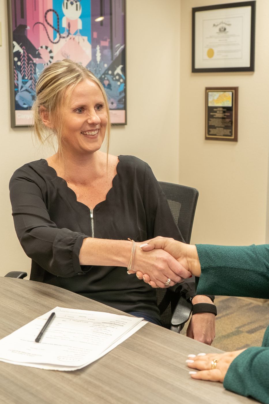 Woman smiling and shaking hands