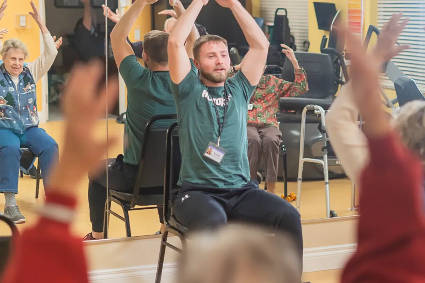 Photo of an activity coordinator conducting a class with seniors